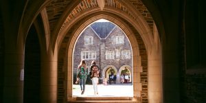 Students walking to class under archway on Duke campus